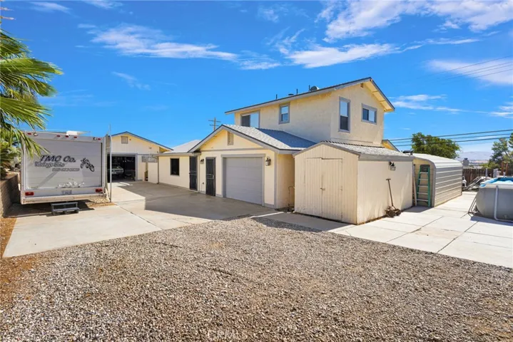 Backyard/side yard. RV partial covered parking. Garage door to workshop. Back Garage door to attached 4 car deep garage.