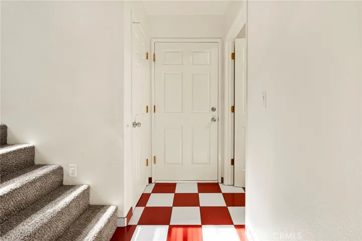 Laundry room to the right. Attached garage entrance and Stairs to secluded Primary Suite