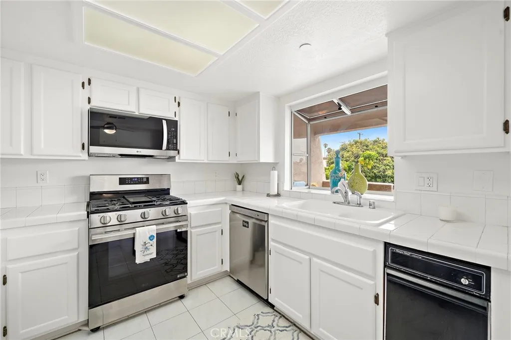 Kitchen looks out to private balcony and neighborhood.