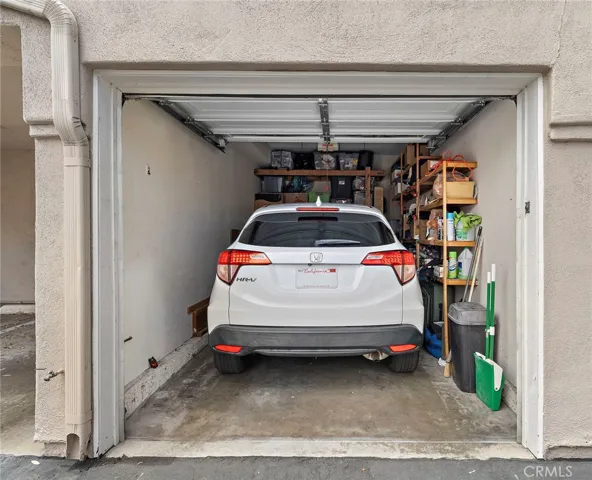 Detached one-car garage with multiple storage options.