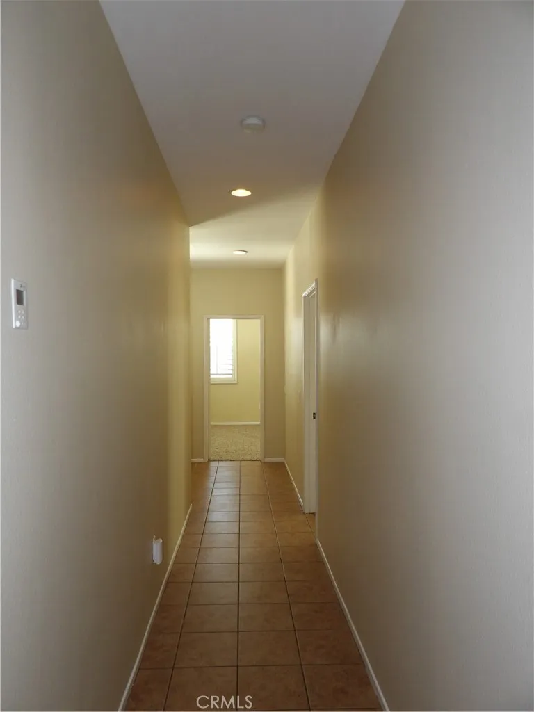 Coming out of kitchen area towards 3 bedrooms.