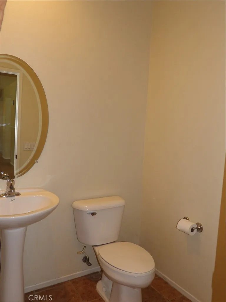 Guest bathroom on opposite side of home, down from living/family rooms.