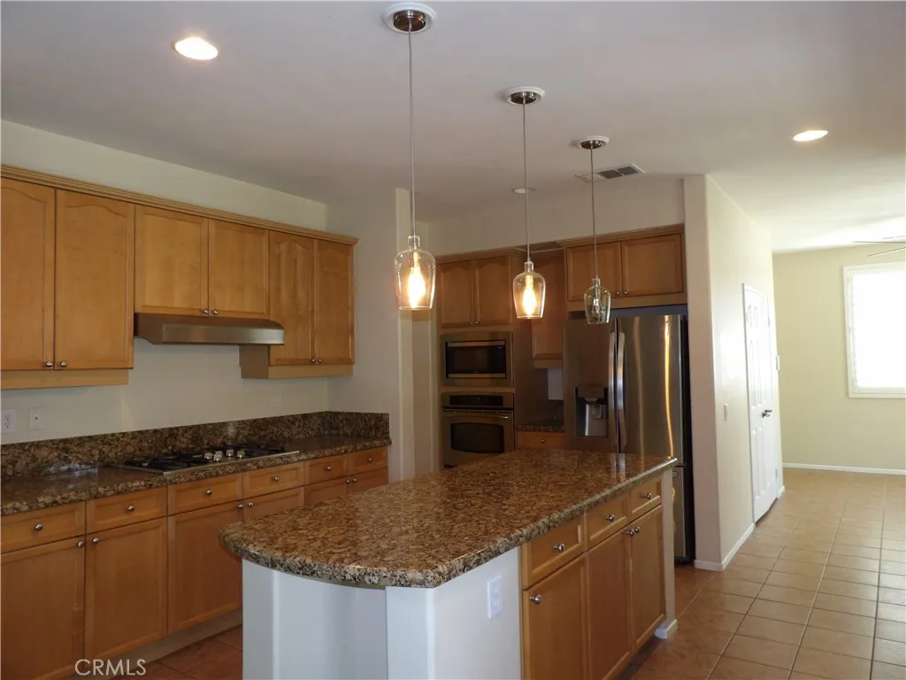 Plenty of cabinets. Small dining area and pantry in the background.