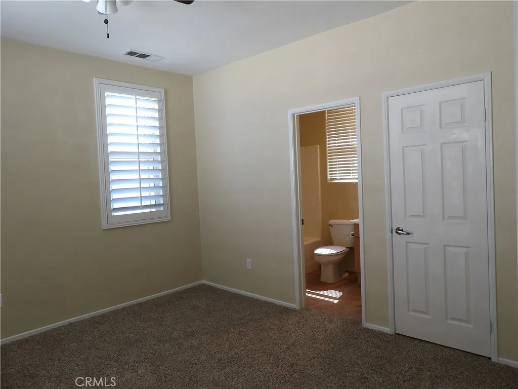 Bedroom #4, with its own full bathroom and walk-in closet. This one faces the front/street.