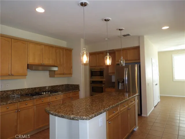 Plenty of cabinets. Small dining area and pantry in the background.