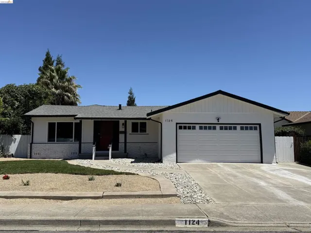 White-painted exterior with black trim, a red entry door, and a white paneled garage door