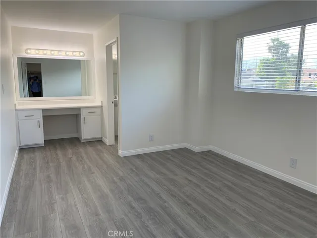 Vanity in Primary bedroom. Wood flooring