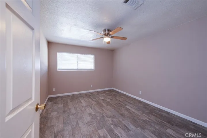 Roomy bedroom 4 overlooks the backyard and has a ceiling fan to keep you cool on those warm days along with a large window for lots of natural light.