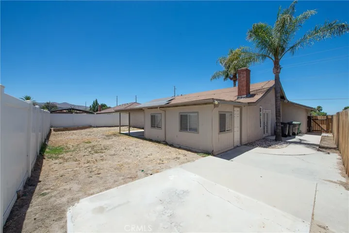 The side of the home has a large cement patio.