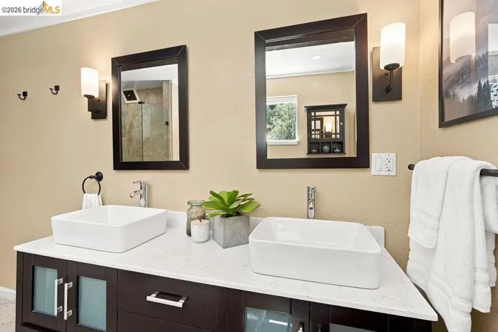 Dual vessel sinks set on a stone-finish countertop
