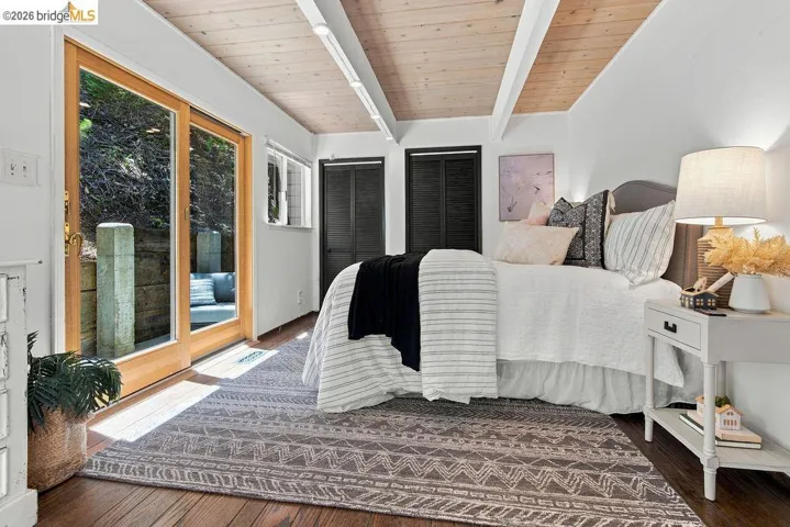 Vaulted wood-paneled ceiling with exposed beams and track lighting
