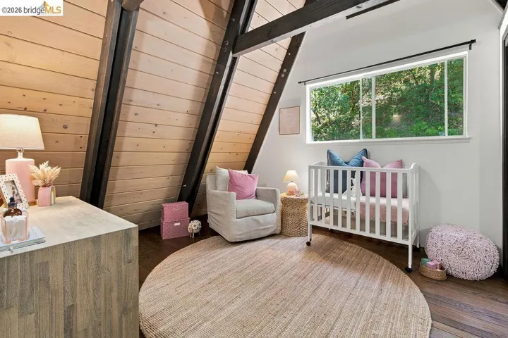 A-frame architecture featuring exposed beams and wood-paneled walls