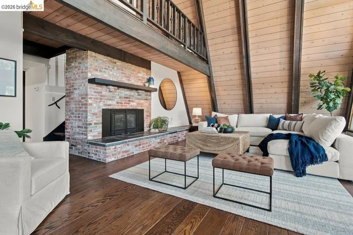 Vaulted ceilings with exposed wood beams and paneling define this living space