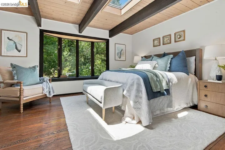 Vaulted wood-paneled ceiling with exposed beams and skylights
