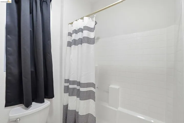 Tub and shower combination featuring white subway tile surround
