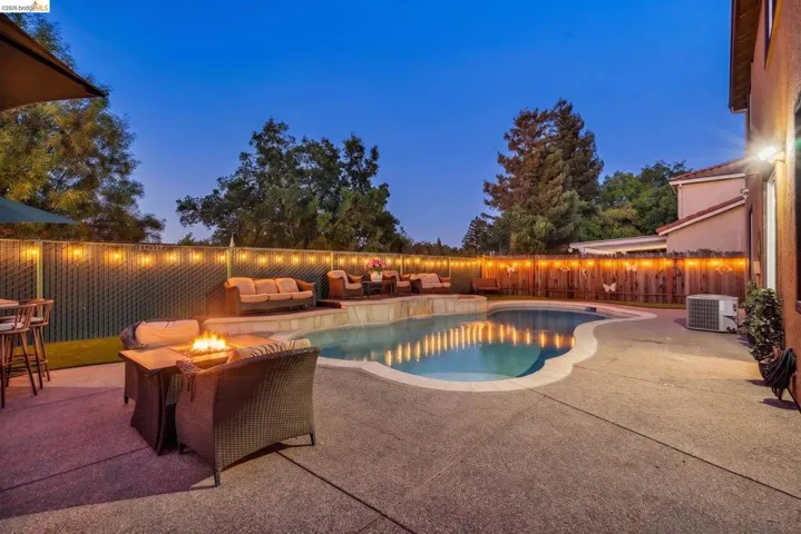 Inviting outdoor space featuring a free-form swimming pool with integrated spa