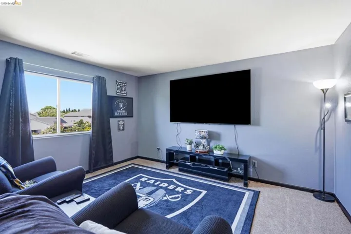 Neutral-toned wall-to-wall carpeting complements the light blue wall finish