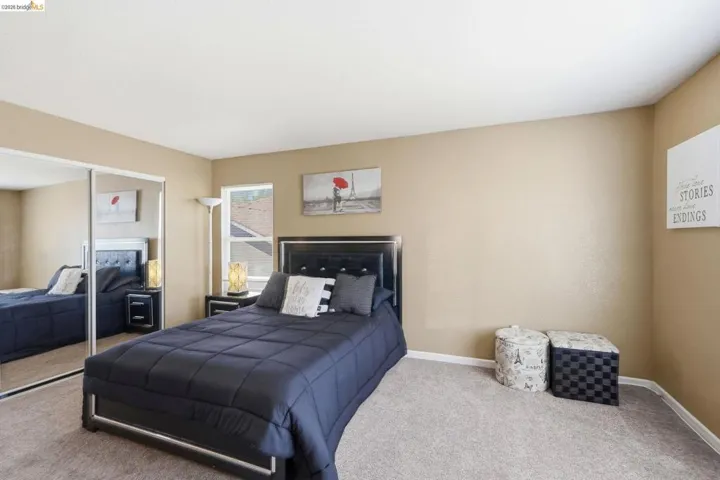 Bedroom featuring neutral-toned walls and light carpet flooring