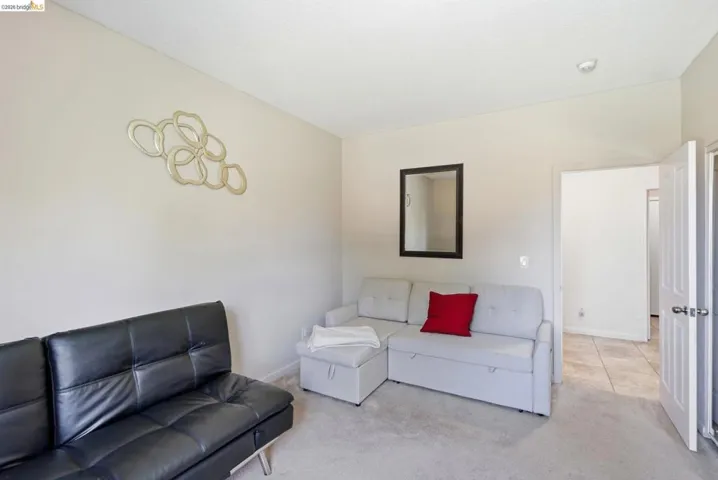 Carpeted room with light-colored walls and a recessed light fixture