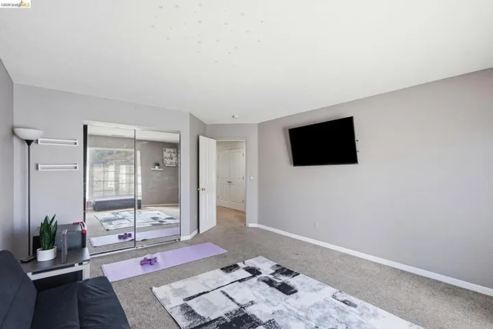 Room featuring light gray walls and neutral carpet