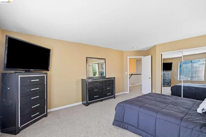 Carpeted interior space featuring a white ceiling and neutral-toned walls