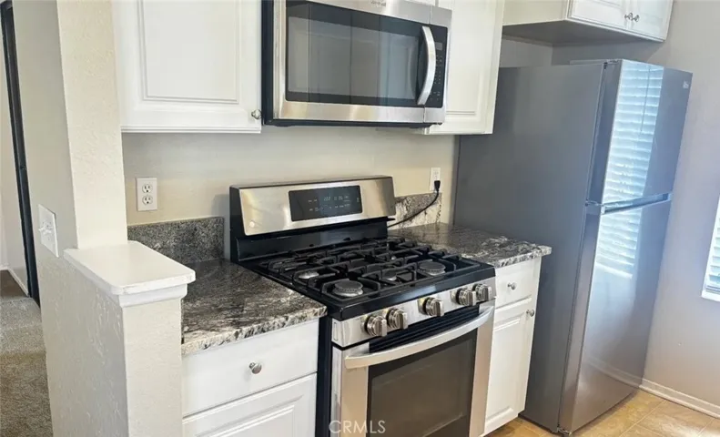 Kitchen range, microwave and refrigerator