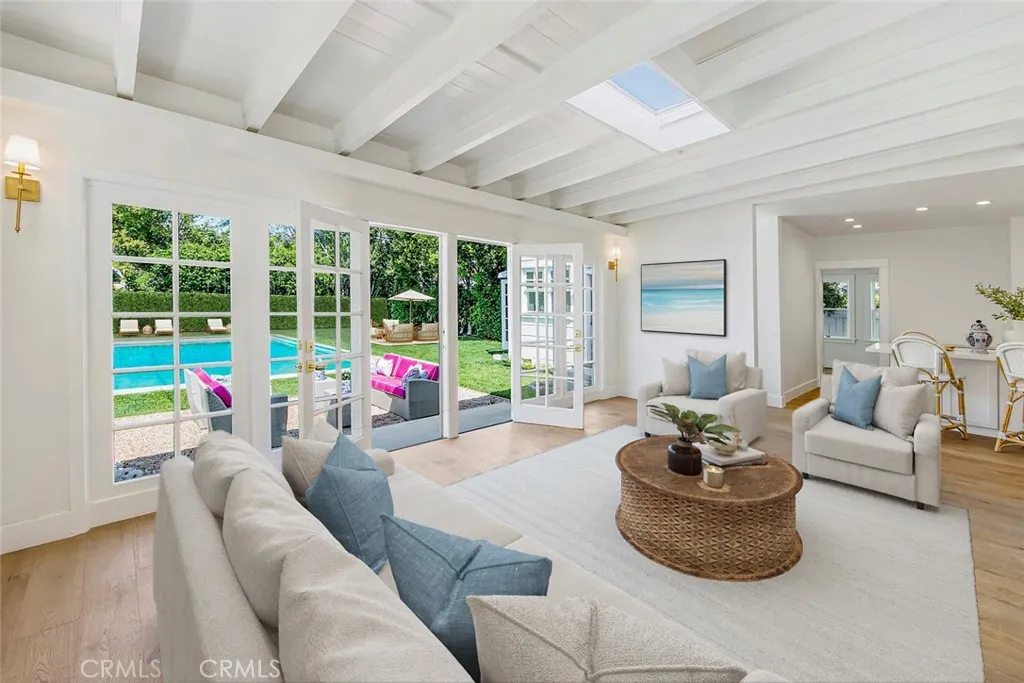 Great Room adjacent to the Kitchen with views of the yard and pool