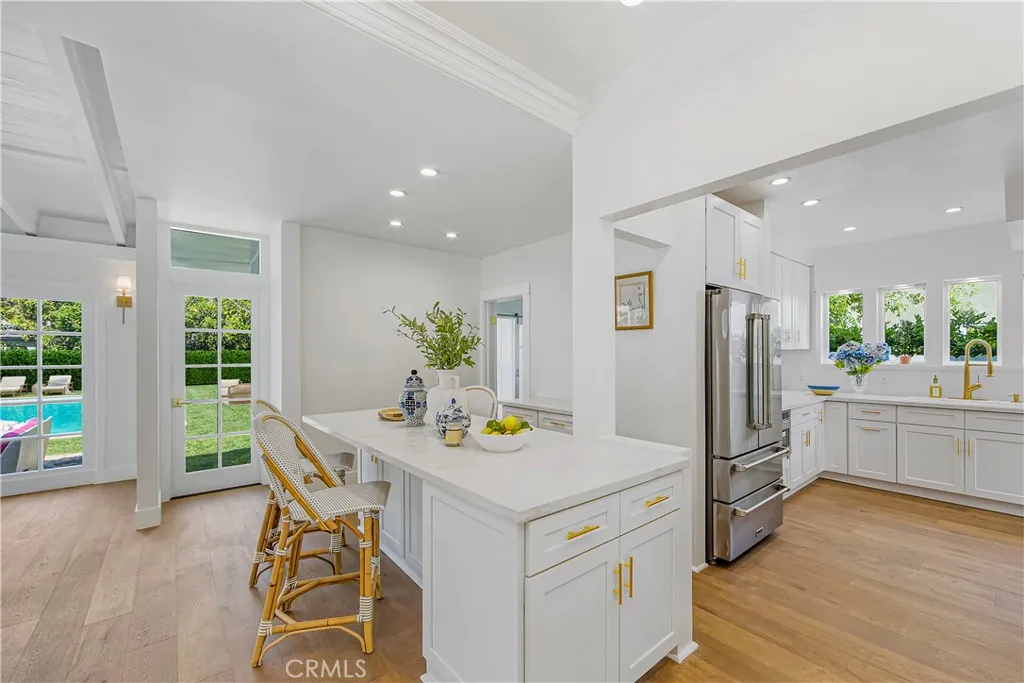 Chef's Kitchen open to Family Room with French doors to the backyard and pool