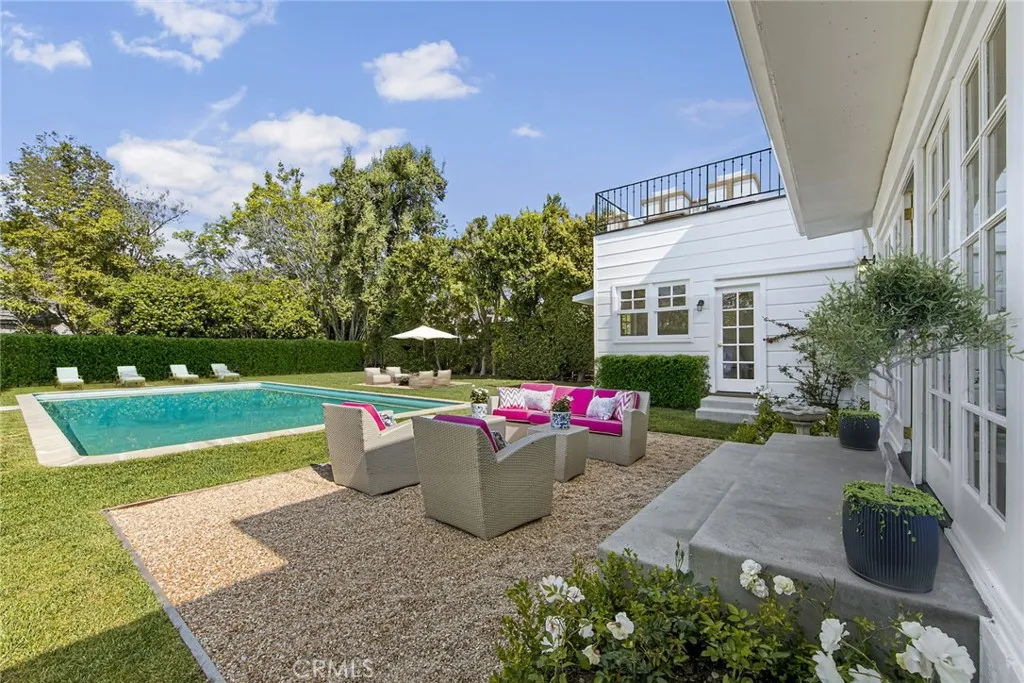 Backyard featuring all new concrete, pebble conversation areas, and grass.