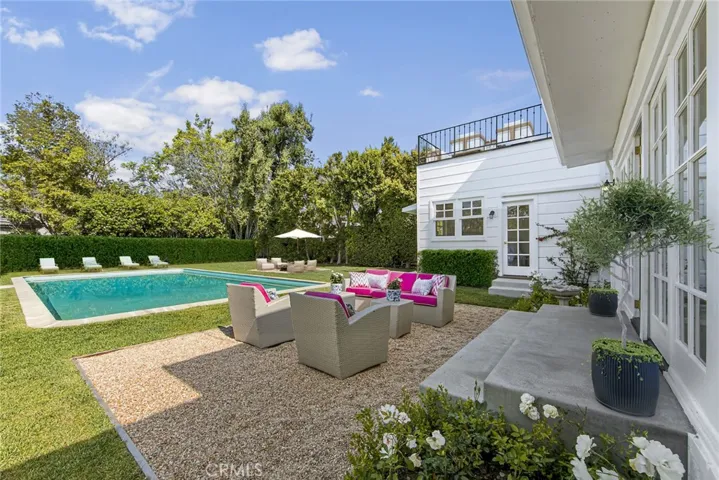 Backyard featuring all new concrete, pebble conversation areas, and grass.