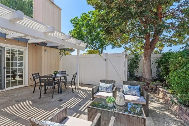Covered patio, dual entertaining spaces, and a picturesque mature tree create the perfect outdoor retreat.