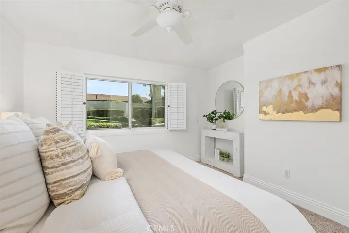 Generous primary bedroom easily accommodates a California King w space to spare.