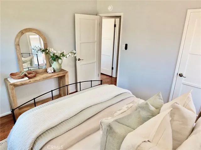 Bright and airy view from the possible primary bedroom highlighting the hallway leading to the second rear bedroom.