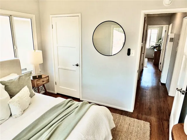 Another view of the front bedroom showing the closet and hallway access and beautiful hardwood floors.