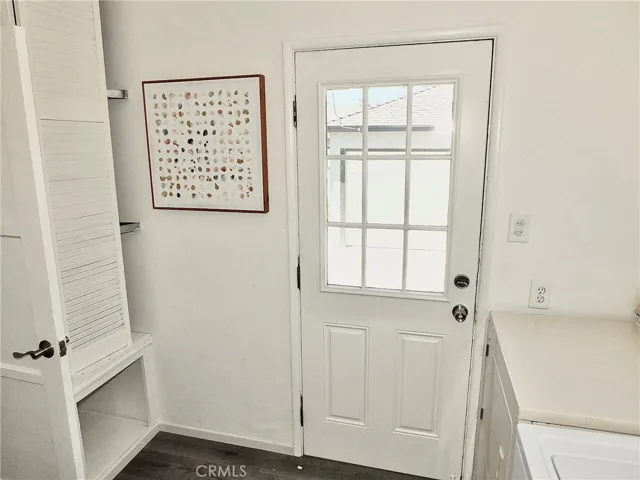 Convenient inside laundry room featuring new flooring and an included washer and dryer.