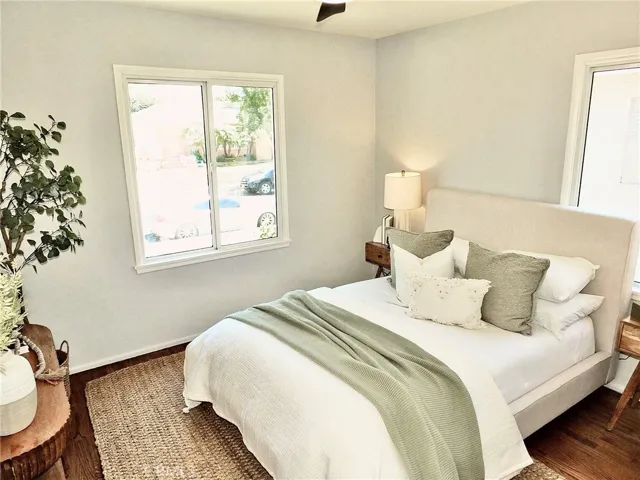Light-filled front bedroom with beautiful hardwood floors and abundant natural light.
