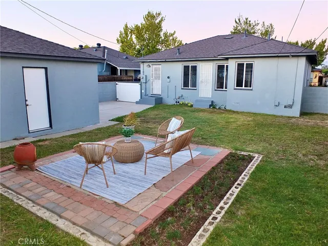 Serene backyard featuring a spacious slate-style patio, perfect for relaxing ,entertaining, or enjoying Southern California living.
