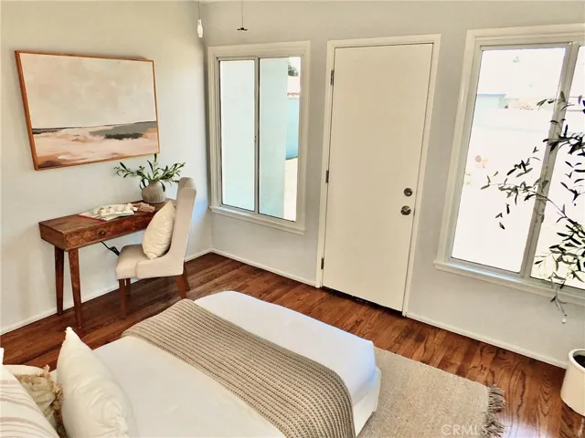 Another view of rear with bedroom beautiful hardwood floors and new windows that look out to the backyard.