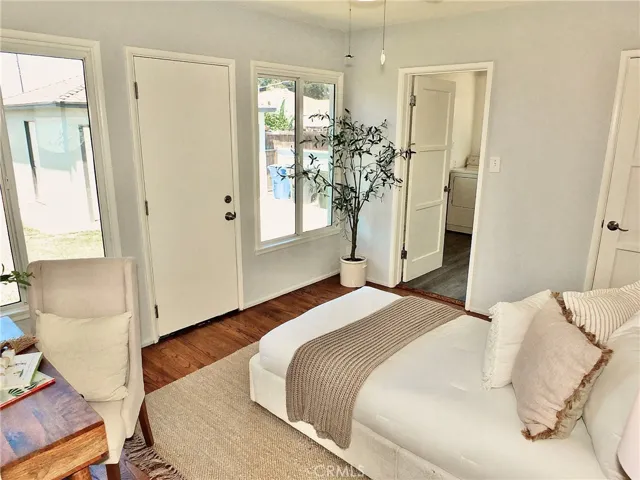 Light-filled rear bedroom with hardwood floors and plenty of space for a home office.