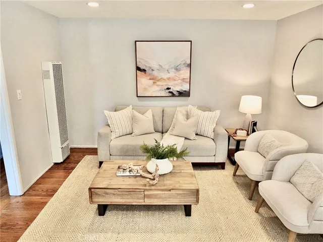 Warm and inviting living room featuring recessed lighting and beautiful hard wood floors.