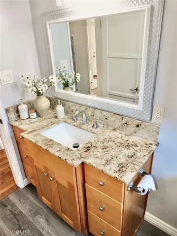 Another view of lovely vanity with finishes that complement kitchen cabinetry and counter.