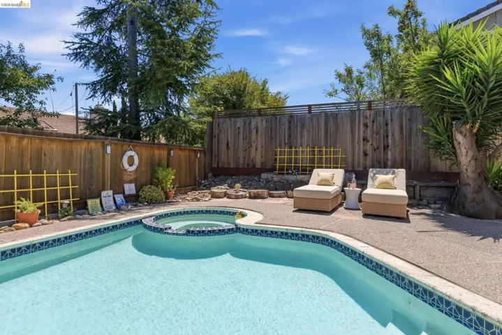 Backyard featuring a custom-shaped swimming pool with an integrated spa
