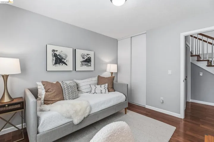 Neutral-toned room featuring wood-finish flooring