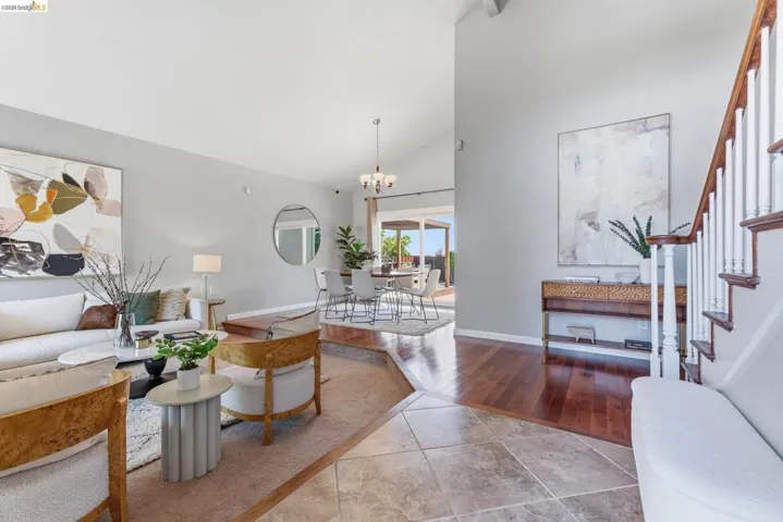 Vaulted ceilings above the living room with an open dining area beyond