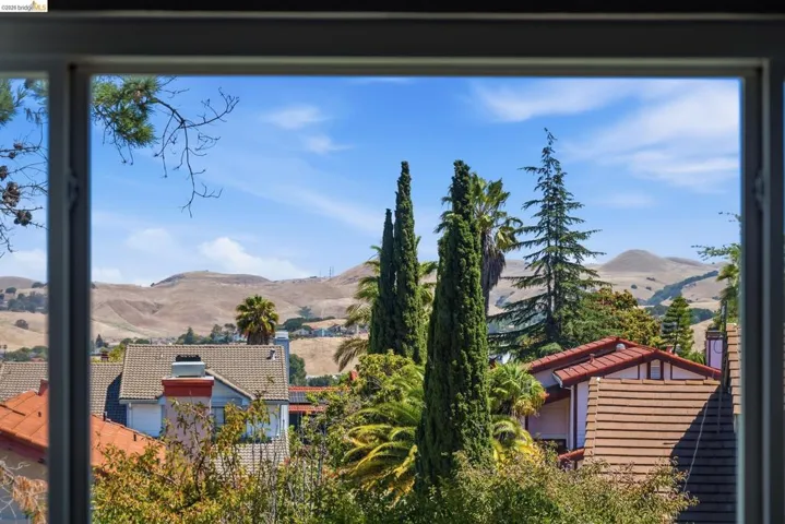 Framed window offering expansive views of distant hills