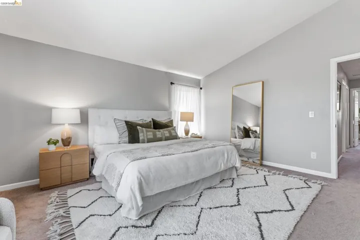 Carpeting throughout featuring an accent rug, light gray wall paint, and white baseboards