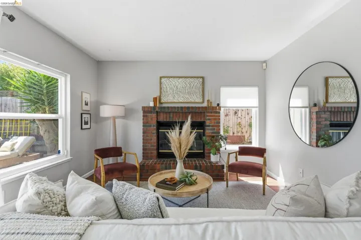 Brick fireplace with a black firebox, light gray walls, and white trim