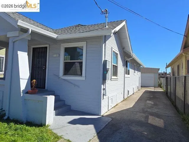 Light blue siding exterior featuring a covered front porch with concrete steps
