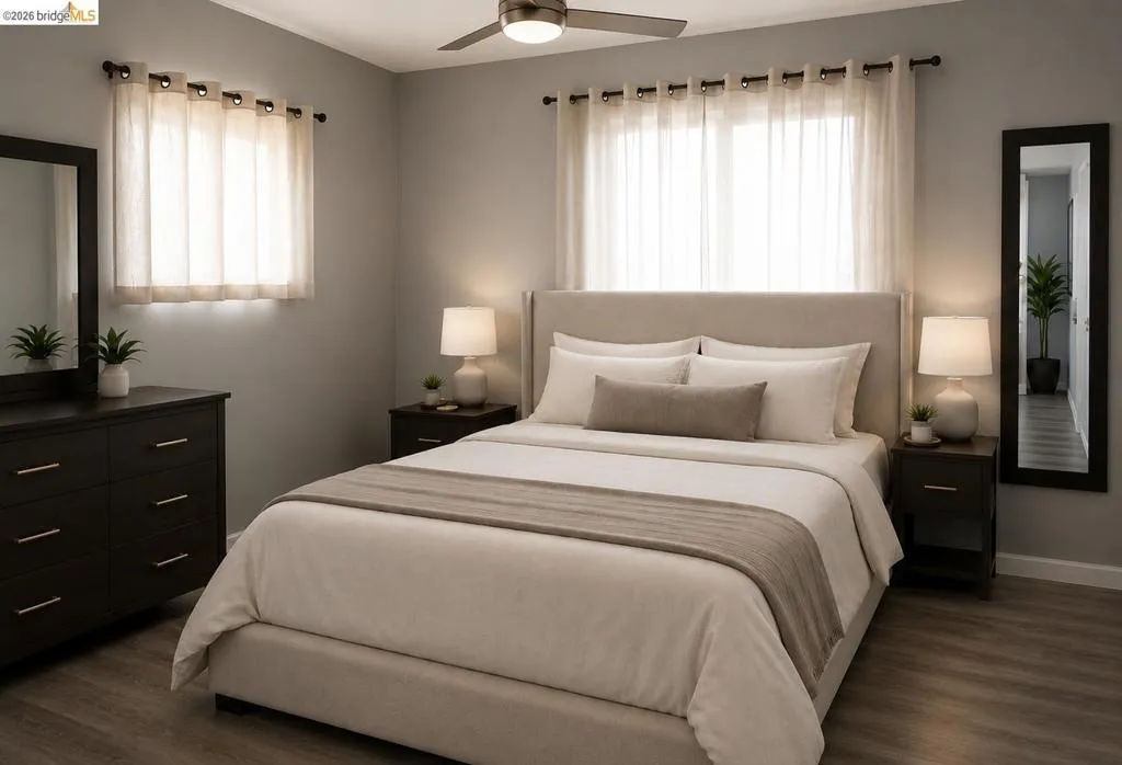 Bedroom featuring wood-finish flooring, a ceiling fan with integrated lighting, and two windows with sheer privacy coverings