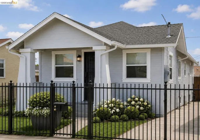 Single-story home featuring light blue siding with white trim